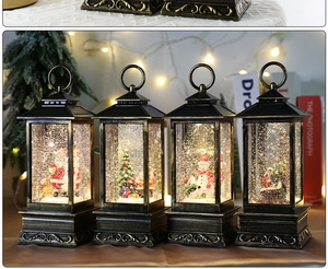 Close-up of vintage bronze Christmas snow globe lanterns with warm LED light and glitter