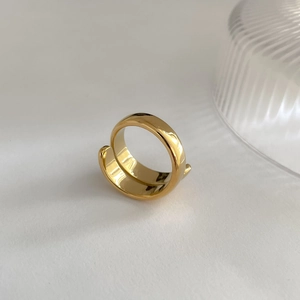 Detailed view of polished gold multi-layer wrap ring with a minimalist open design