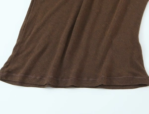 Close-up of the rolled hem and double-needle stitching on coffee brown cotton fabric