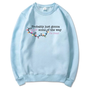 Detail of light blue sweatshirt collar showing the M size tag and soft cotton fabric texture