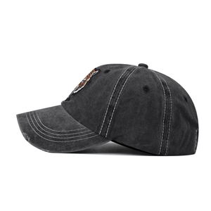 Close-up of tiger head embroidery and distressed brim on washed cotton baseball cap