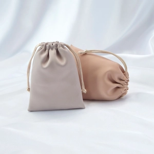 Detail of luxury microfiber drawstring jewelry pouches in dusty pink and light grey