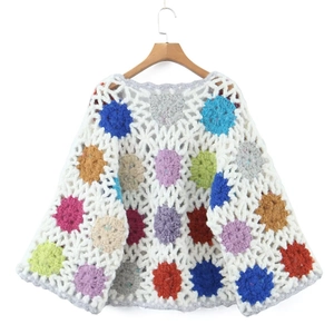 Handmade crochet knit cardigan featuring colorful floral patterns on a white base