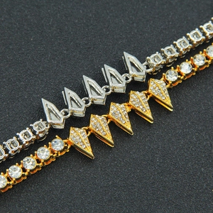 Close-up of hip hop cuban necklaces with rhinestones and sharp tapered studs in gold and silver