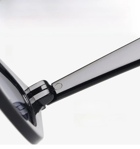 Detail of durable hinges on black cat-eye sunglasses for smooth folding and daily use