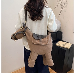 Close-up of a brown horse-shaped felt shoulder bag featuring a saddle-style flap pocket