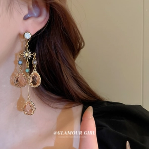 Vintage water drop tassel earrings with sparkling crystals worn by a model
