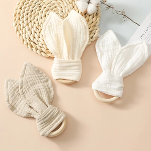 Three-piece infant teething rings with organic cotton rabbit ears in natural earthy tones