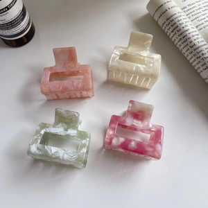 Elegant geometric acetate claw clips in four marble patterns for stylish hair styling