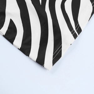 Macro view of high-quality zebra print fabric with precise double-needle stitching detail