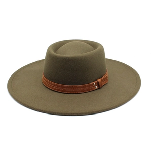 Detail of olive wool fedora hat featuring brown leather band and metal rivet buckle