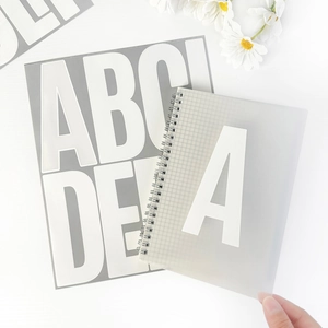 Close-up of 5-inch large alphabet stickers on a frosted spiral notebook for home decor