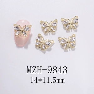 Macro view of gold butterfly nail art charms with clear rhinestones and 14x11.5mm size