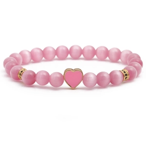 Pink cat eye stone beaded bracelet with gold heart charm and black zircon accents