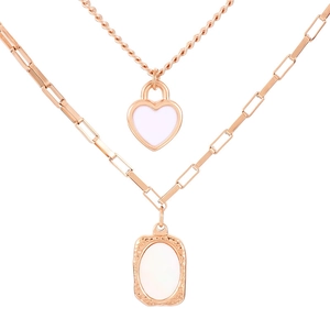 Double layered necklace in rose gold with heart and oval pendants on a white background