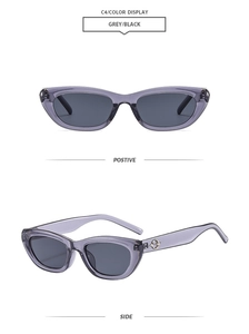 Detail view of transparent grey cat-eye sunglasses with metal accents and dark lenses