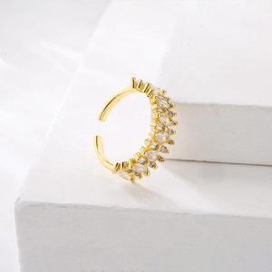 Gold plated geometric open ring with marquise cubic zirconia on stone pedestal