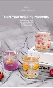 Detailed view of colorful jelly candles with dried flowers and gold leaf in glass cups