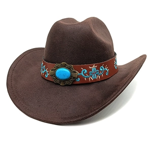 Detailed view of dark brown cowboy hat with turquoise stone and embroidered leather band