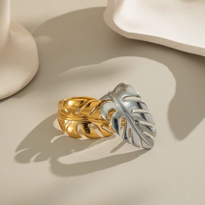 Polished stainless steel monstera leaf rings in gold and silver finishes for women