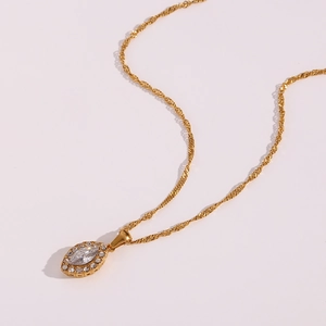 Macro detail of marquise cut cubic zirconia pendant with pavé crystals in gold finish