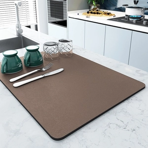 Dark brown absorbent kitchen draining mat on marble countertop for coffee machine