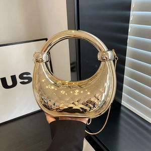 Golden crescent handbag with metallic mirror finish and diamond quilted pattern