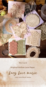 Detailed laser-cut paper lace decorations featuring butterflies and gothic window patterns