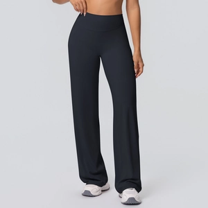 Detail of high-waisted black yoga pants with wide-leg design and flattering slim fit