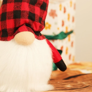 Macro view of Christmas gnome fabric textures with red plaid hat and soft plush beard