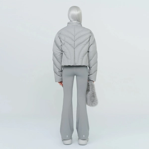 Back view of a trendy gray cropped puffer jacket and slim-fit flared trousers