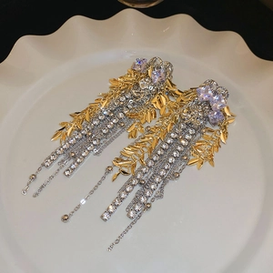 Macro view of luxurious floral wheat ear tassel earrings with sparkling crystals