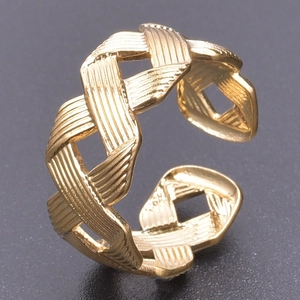 Macro detail of gold-plated braided hollow ring showing brushed metal texture and open band