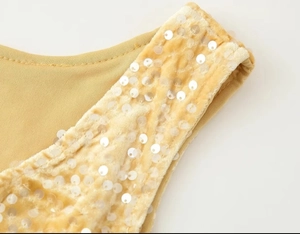Detailed close-up of gold sequin embroidery on high-quality velvet fabric and fine stitching
