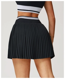 Rear view of black pleated tennis skirt featuring a striped elastic high waistband