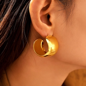 Modern wide C-shape gold-plated stainless steel earrings with glossy metallic finish
