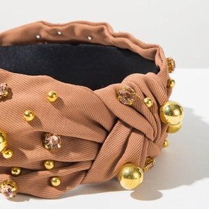 Detail of caramel brown knotted headband with gold beads and sparkling crystal accents