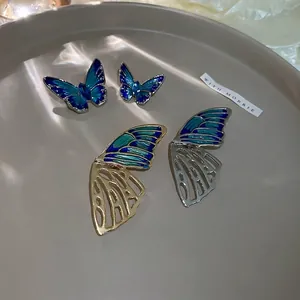 Exquisite hollow butterfly brooch with blue enamel and rhinestones on ceramic tray