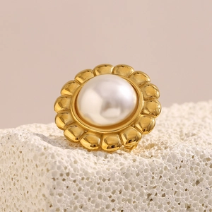Macro detail of high-luster pearl nestled in a vintage 18K gold-plated floral ring base