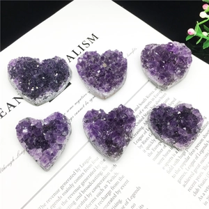 Group of six heart-shaped natural purple amethyst clusters on a vintage paper background