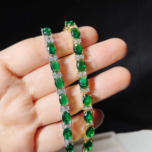 Detailed view of silver and gold emerald oval-cut tennis bracelets with AAA zircon stones