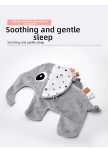 Detail of grey elephant plush security blanket with polka dot ears and ribbon tags