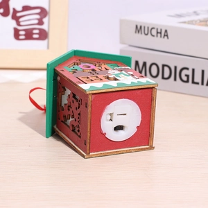 Detail of wooden LED Christmas house ornament with HOME roof and snowman design