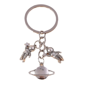 Vintage silver astronaut keychain featuring a planet charm and astronaut pendants