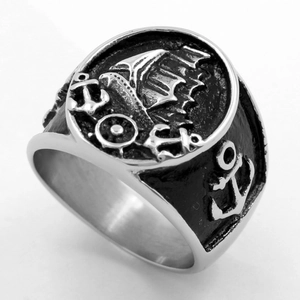Vintage stainless steel nautical ring featuring embossed sailboat and anchor patterns