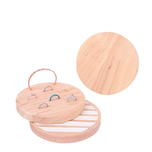 Minimalist round solid wood jewelry display stands for rings and bracelets on white backdrop