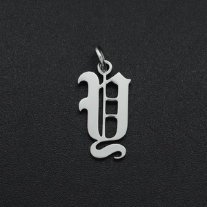 Close-up of polished silver stainless steel letter U pendant with smooth metallic finish