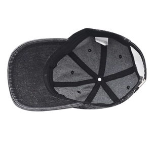 Interior detail of washed cotton denim baseball cap showing sweatband and 100% cotton label