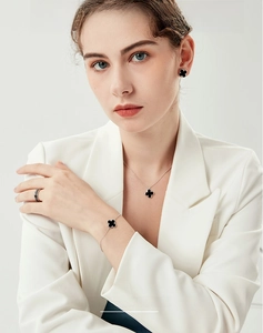 S925 silver jewelry set with black onyx clover necklace, bracelet, and earrings on model