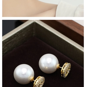 Close-up of pearl earrings with gold floral base and shimmering zircon stones details